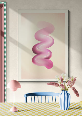 Framed Retro Graphic No.6 print with pink abstract swirl, displayed above a table with flowers and lamp.