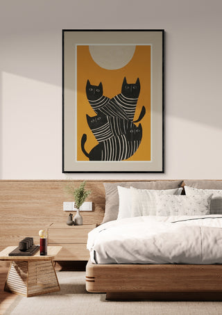 Framed print of abstract black cats by Branka Kodžoman hanging above a modern bed in a cozy bedroom.