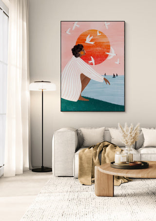 Framed "Sunset On My Own" by Bea Muller hanging above a beige sofa in a modern living room.