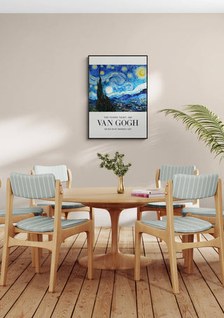 Framed "The Starry Night" Van Gogh poster hanging above a dining table with four chairs in a modern room.