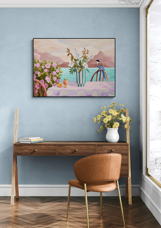 Framed Peachy Evenings - Goed Blauw artwork above a wooden desk in a stylish, modern room with blue walls.