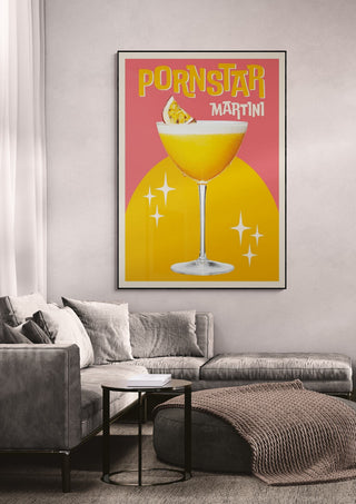 Poster of a Pornstar Martini cocktail with vibrant colors, hanging on a living room wall above a modern sofa.