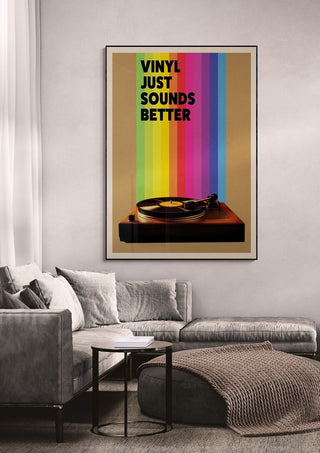 Framed "Vinyl Just Sounds Better" wallchart with a turntable and rainbow stripes, displayed above a sofa.