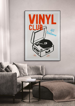 Framed Vinyl Club wallchart featuring a record player, displayed above a modern living room sofa.