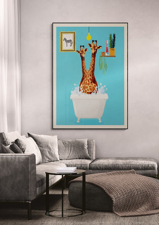Wallchart featuring two giraffes in a bathtub, displayed above a modern grey sofa in a living room.