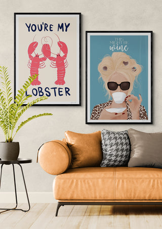 Framed "You're My Lobster" artwork by ByKammille displayed above a tan sofa in a modern living room.