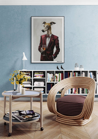 Framed Zoophisticated Martin Zen artwork of a dog in a suit above a modern chair in a stylish living room.