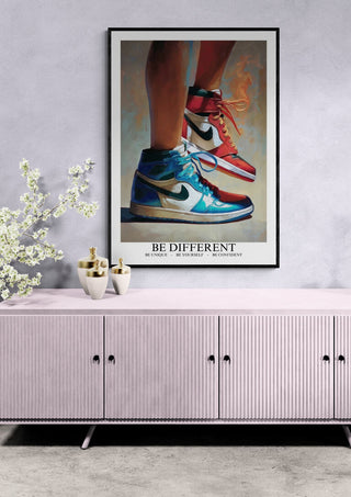 Framed "Be Different Jordan" art by Martina Karlsson featuring colorful Nike sneakers, displayed above a modern cabinet.