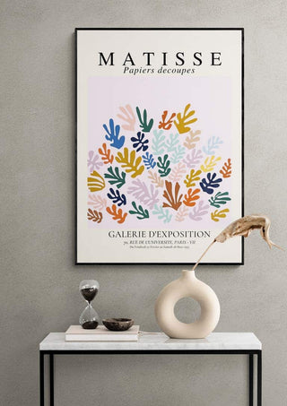 Framed Matisse The Sheef Refurbished art print on a wall above a white console table with decor items.