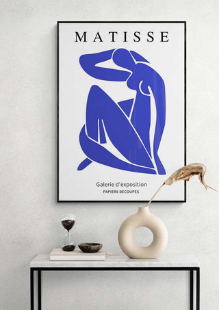 Framed Matisse Blue Nude print displayed above a modern console table with minimalist decor.