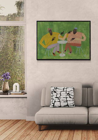 Framed Studio IMO artwork above a beige sofa with patterned pillow in a modern living room.
