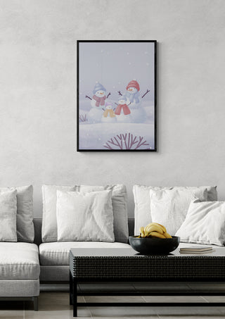 Framed Snowman Family artwork hanging above a modern sofa in a living room setting.