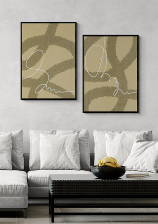 Drift Loop II - Yuli abstract wall art in black frames displayed above a modern gray sofa with cushions.