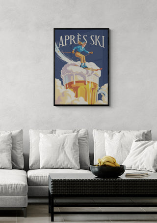 Framed Apres Ski Vintage poster featuring a skier on snowy peaks, displayed above a modern sofa.