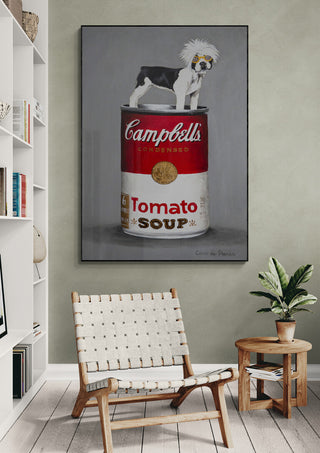 Pop art print of a bulldog on top of a Campbell's tomato soup can, displayed in a modern living room.