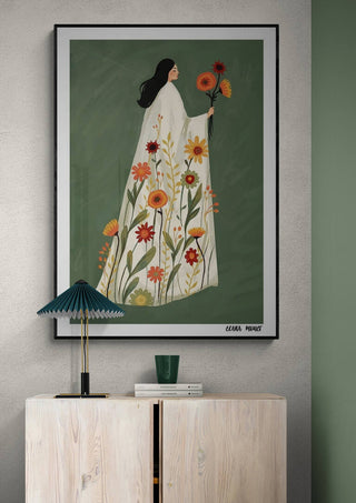Framed "Blooming Grace" artwork by Elara Monet featuring a woman in a floral dress holding flowers.